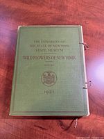 Front cover of green tied portfolio with title and 1921 date