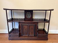 Full view of rosewood display cabinet showing shelves, cupboard, drawers, fretwork, curved top