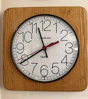Front view of Landmark wooden wall clock showing dial and frame