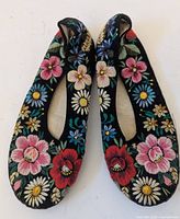 Top view of both ballet flats showing full floral embroidery
