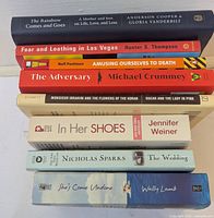 Side-stack view of all eight paperback spines showing titles and authors