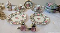 Group shot showing plates, cups, saucers, trinket box, egg ornament, porcelain flower holders and metal rings