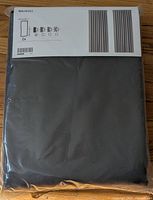 Front of sealed package showing dark gray curtains and product label