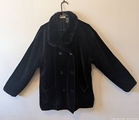 Front view of black double-breasted coat on hanger