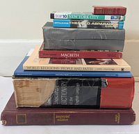 Stacked view of nine books showing spines and bindings