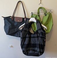 All three handbags hanging to show size and style