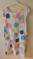 Front view of white multicolor polka dot dress on hanger