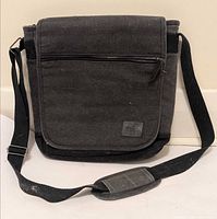 Full view of Roots 73 black/charcoal canvas messenger bag with strap