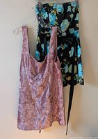 Front view of both dresses hanging