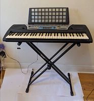Keyboard on stand with music rest attached