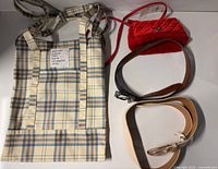 All items overview: plaid tote, red crossbody, three belts