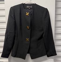 Full view of blazer on hanger showing front, sleeves, buttons