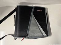 Front view of black and grey Case-it zippered binder with strap and handle
