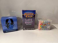 Snug ear defenders box, Family Feud Late Night game box, Play Day sidewalk chalk tub