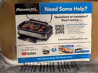 Front of pamphlet showing PowerXL Smokeless Grill information inside box