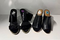 Both pairs of black Calvin Klein open-toe shoes displayed side by side