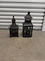 Both lanterns side by side on floor showing design styles