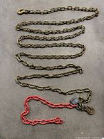 Full view of yellow tow chain and red chain with padlock and hook