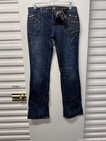 Full front view of the blue denim jeans hanging