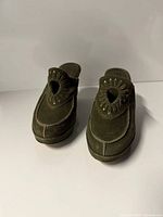 front view of Frye green suede mules showing cut-out detail and toe design