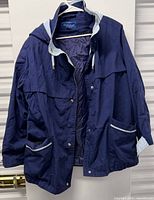 Front view of navy hooded coat showing pockets and lining
