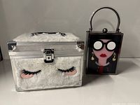 Makeup case and handbag side by side, closed view