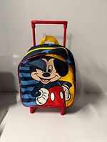 Front view showing Mickey Mouse graphic, fabric colours and trolley handle.