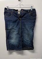 Full front view of Moschino Jeans blue denim dress on hanger