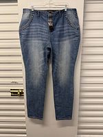 Front view of Ashley Stewart blue denim jeans with tag attached