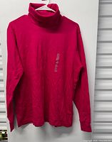 Front view of red turtleneck sweater hanging
