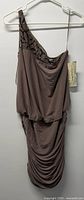 Front view of taupe one-shoulder dress on hanger