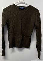Front view of olive heather cable knit sweater on hanger