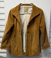 Front view of brown corduroy Rip Curl jacket on hanger