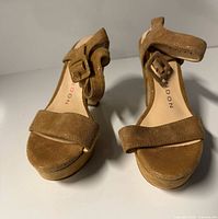 Front view of both sandals showing toe straps and ankle buckles