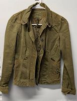 Full front view of olive Sanctuary jacket on hanger