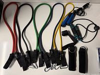 Full lot overview showing five resistance bands, jump rope, straps and handle