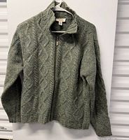 Full view of zip-up cable-knit Talbots jacket on hanger