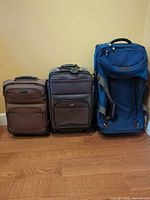 Three pieces of luggage standing side by side