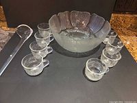 Complete punch set laid out: bowl, ladle, eight cups