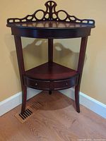 Full view of corner table showing two tiers and fretwork back
