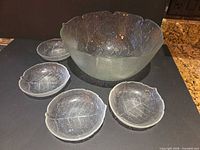 Full set: large bowl and four small bowls displayed