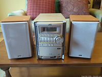Front view of JVC main unit flanked by two speakers