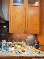 All items on countertop under cabinet showing overall lot