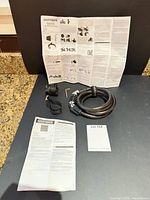 All components laid out: combination lock coiled, bracket, Velcro strap, Allen key, instructions