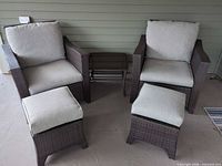 Both armchairs, both ottomans and side table front view