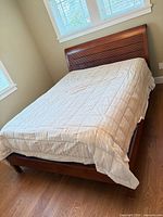 Full view of assembled queen sleigh bed frame with slatted support