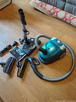 Main canister, hose, heads, tools and HEPA bag box on floor