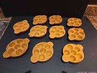 All ten stoneware escargot plates displayed