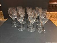 front view of 11 stemmed clear wine glasses