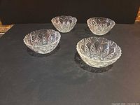 All four clear pressed glass bowls top view